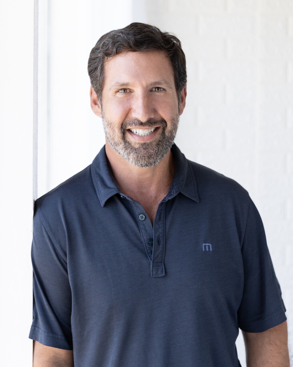 Jonathan wearing blue shirt and smiling