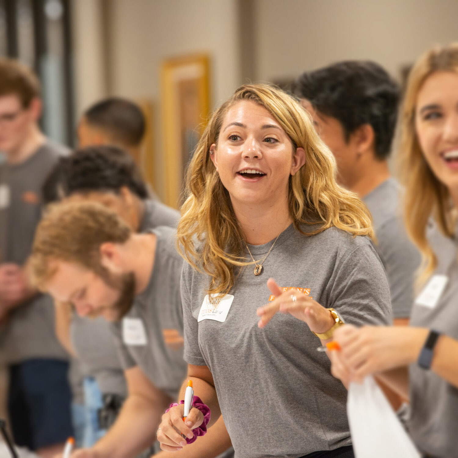 female student with long blonde hair wearing gray shirt