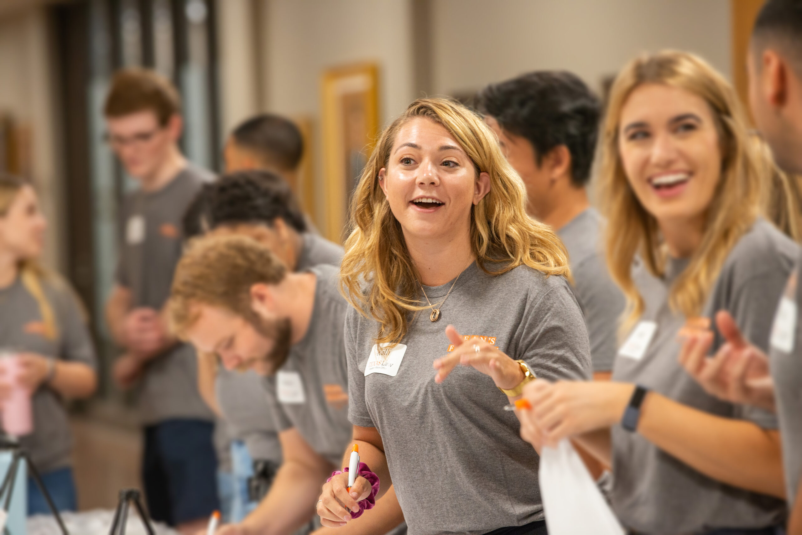 female student with long blonde hair wearing gray shirt