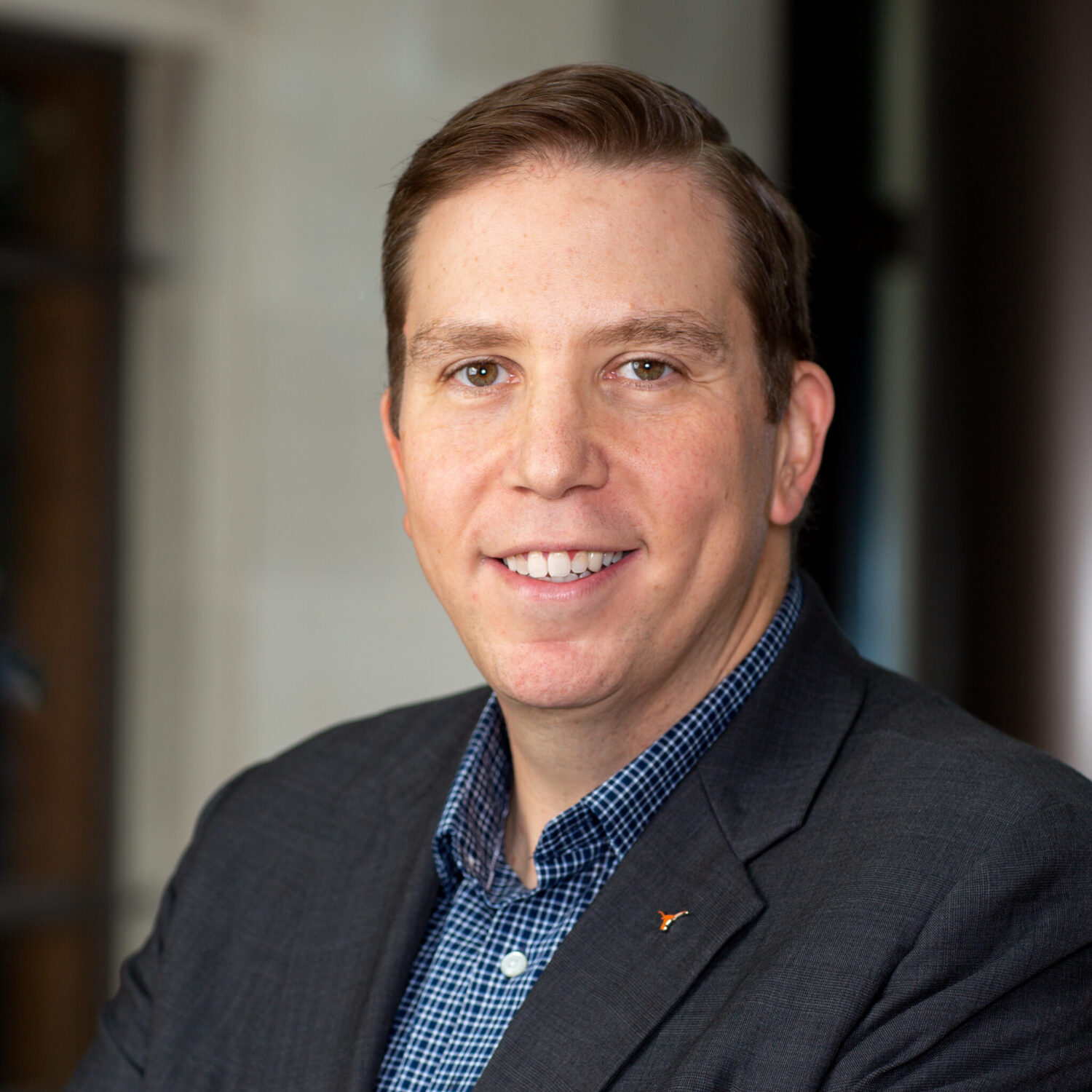 Portrait of man wearing gray blazer