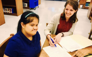 Law student working with elementary student