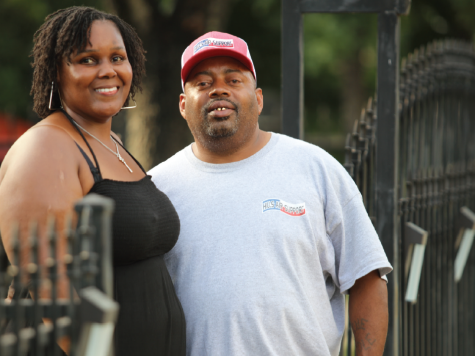 Austin homeowners stand outside their property.