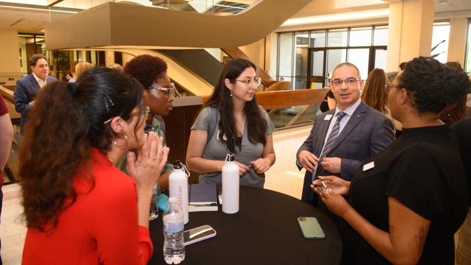 Dr. Samuel Riley visits with admitted students in the atrium 2023