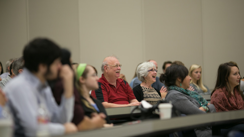 Parents participate in a mock class during Family Weekend