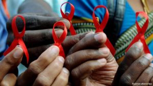 people holding aids awareness ribbons
