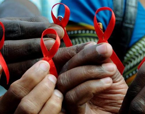 people holding aids awareness ribbons
