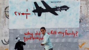 young man standing next to wall about US drones