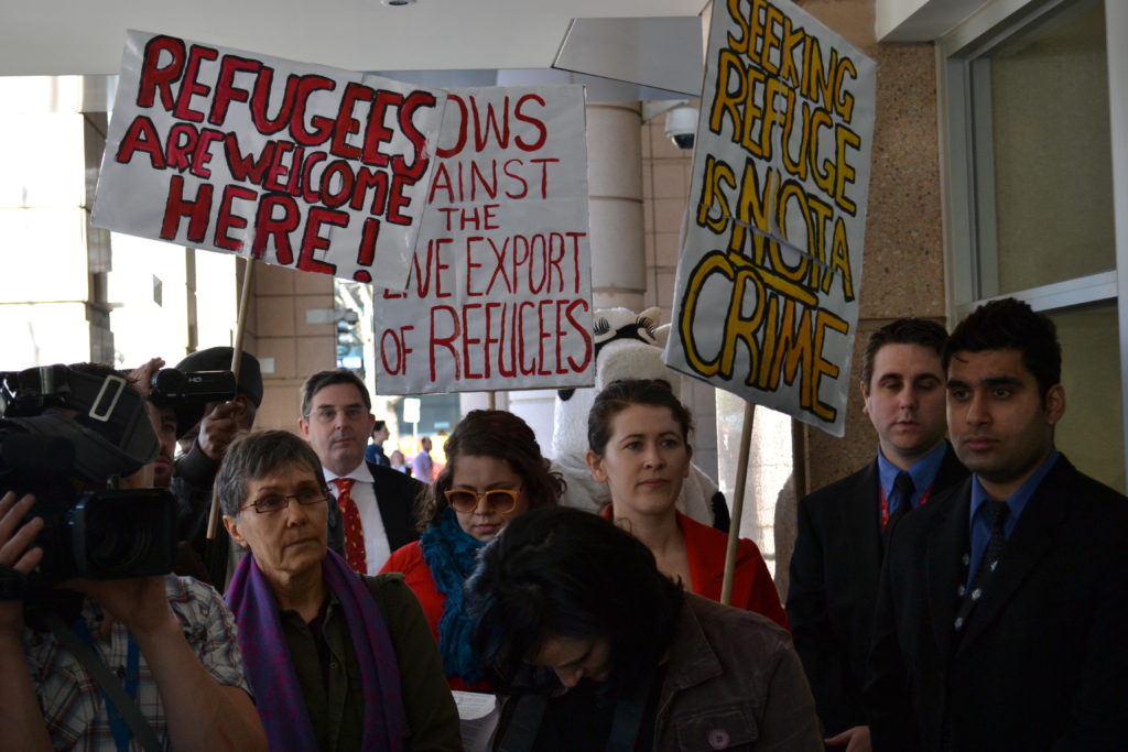 protestors hold signs