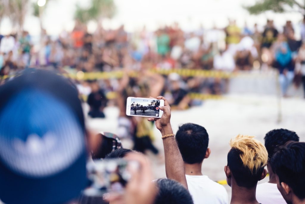 person taking video of protest