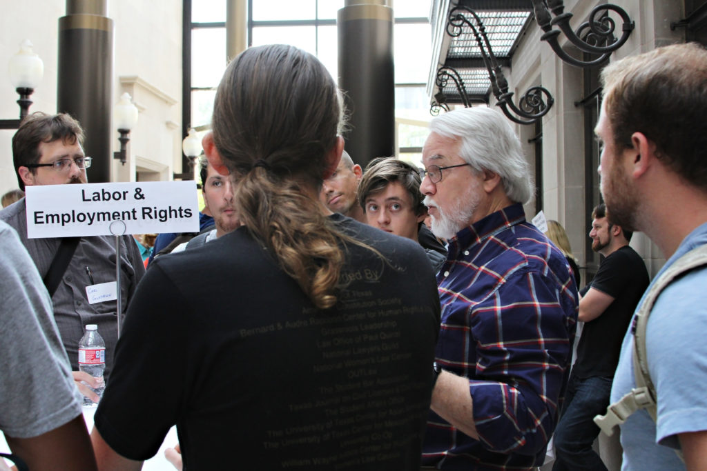 Students standing and talking to professor