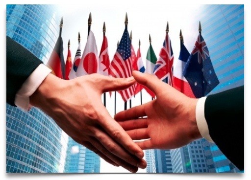 two hands shaking with country flags in backgroun