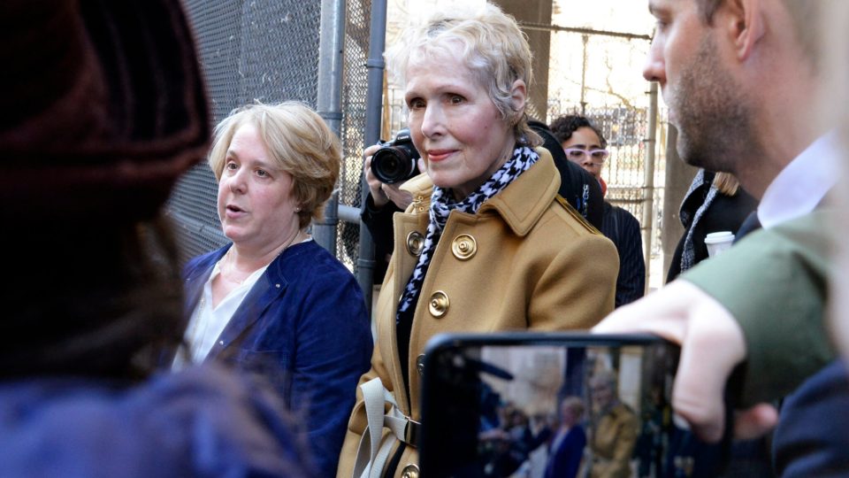 E. Jean Carroll being photographed by an individual with a cell phone