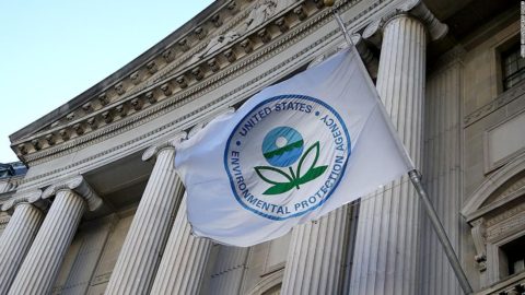 The flag of the Environmental Protection Agency flies in front of a federal building