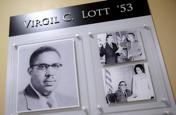 Three photos in wall plaque honoring Virgil C. Lott '53