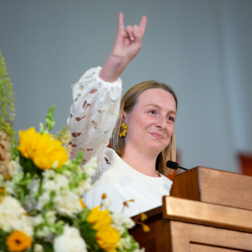 Emma Culotta doing "Hook 'Em Horns"