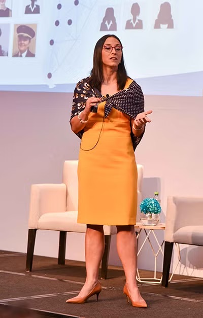 Alina Nassar gives a speech onstage.