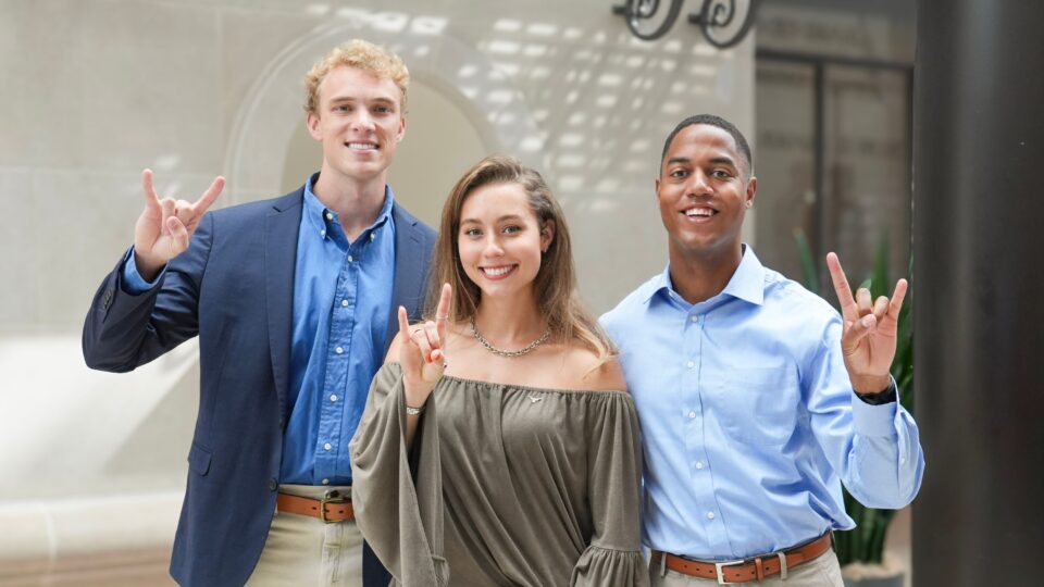 Cooper Tyler, Chandler Lawn, and Joe Holden pose in the law school