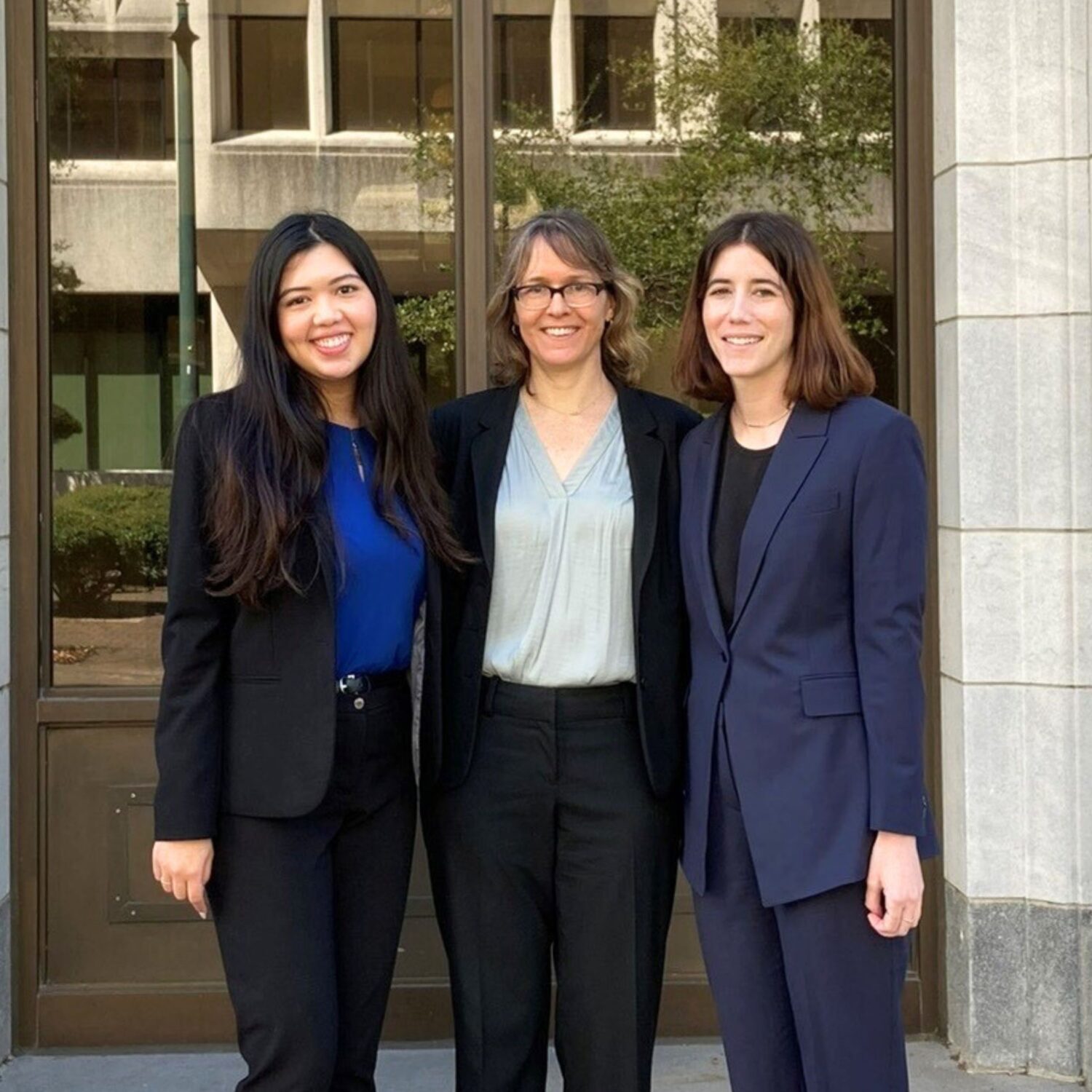 Three women standing outside court building. Lisette Chan ’24, Professor Elissa Steglich, and Annie Fogel ’24