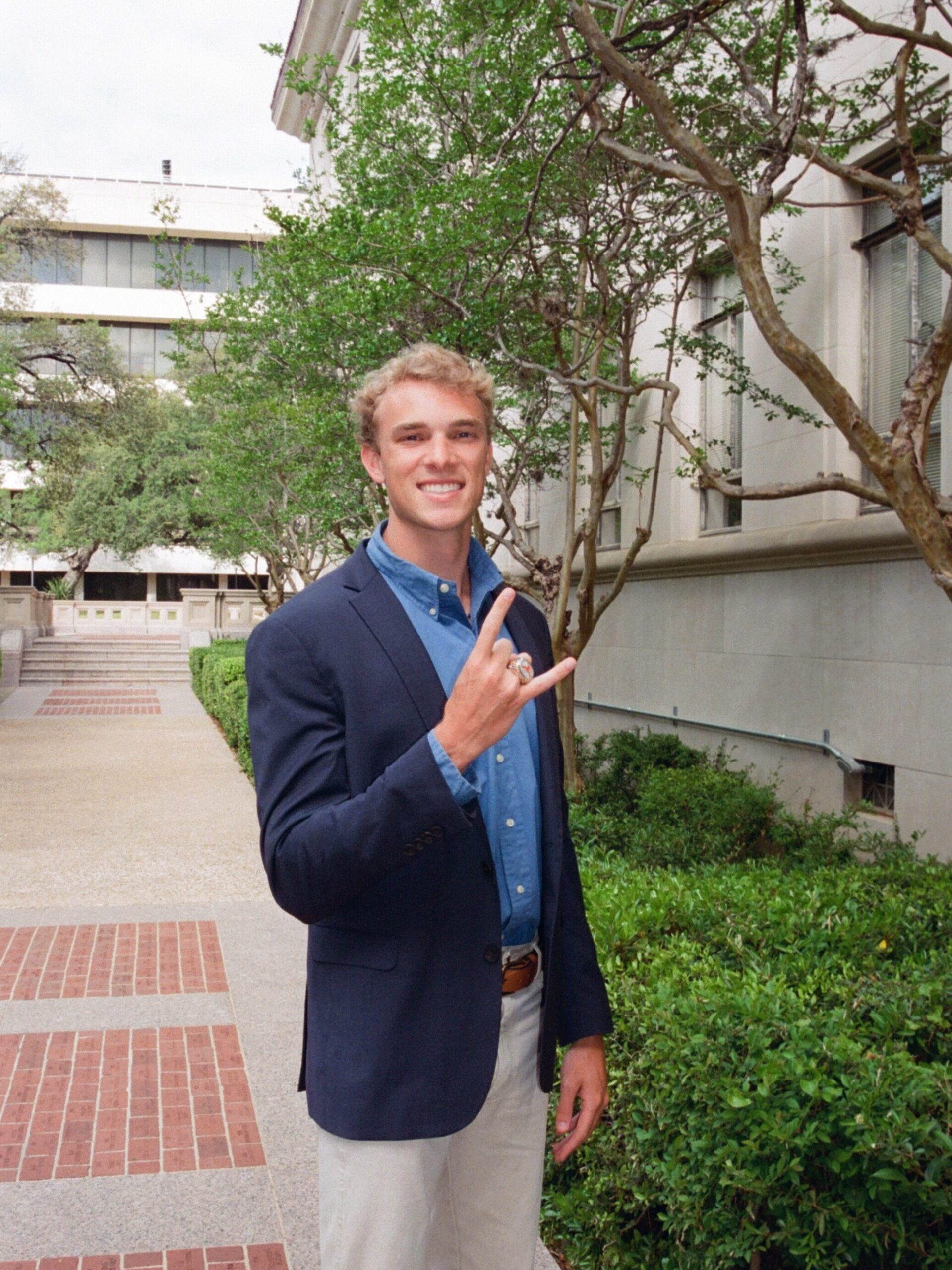 Cooper Tyler holding Hook 'em hands