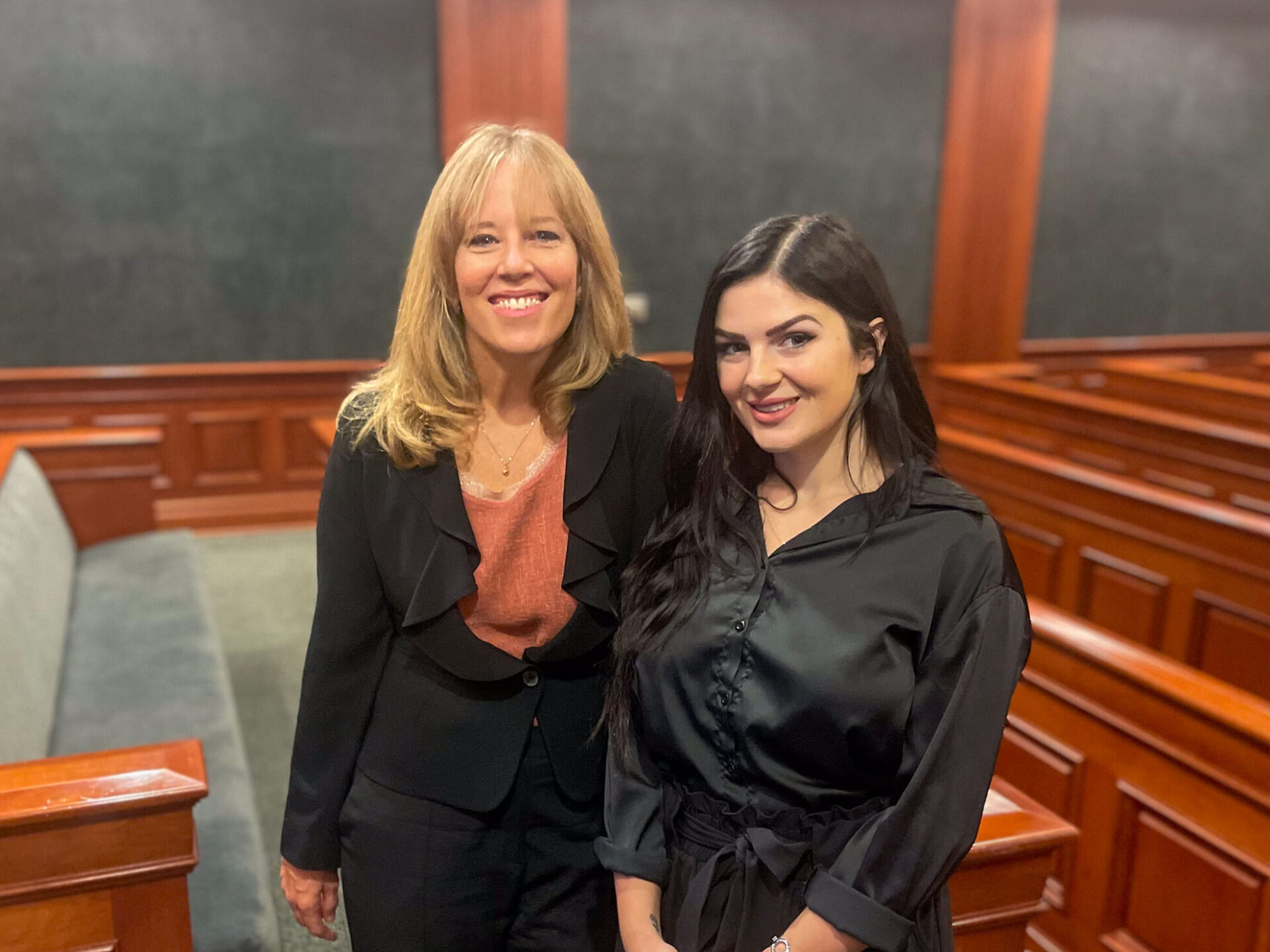 Two women standing in courtroom