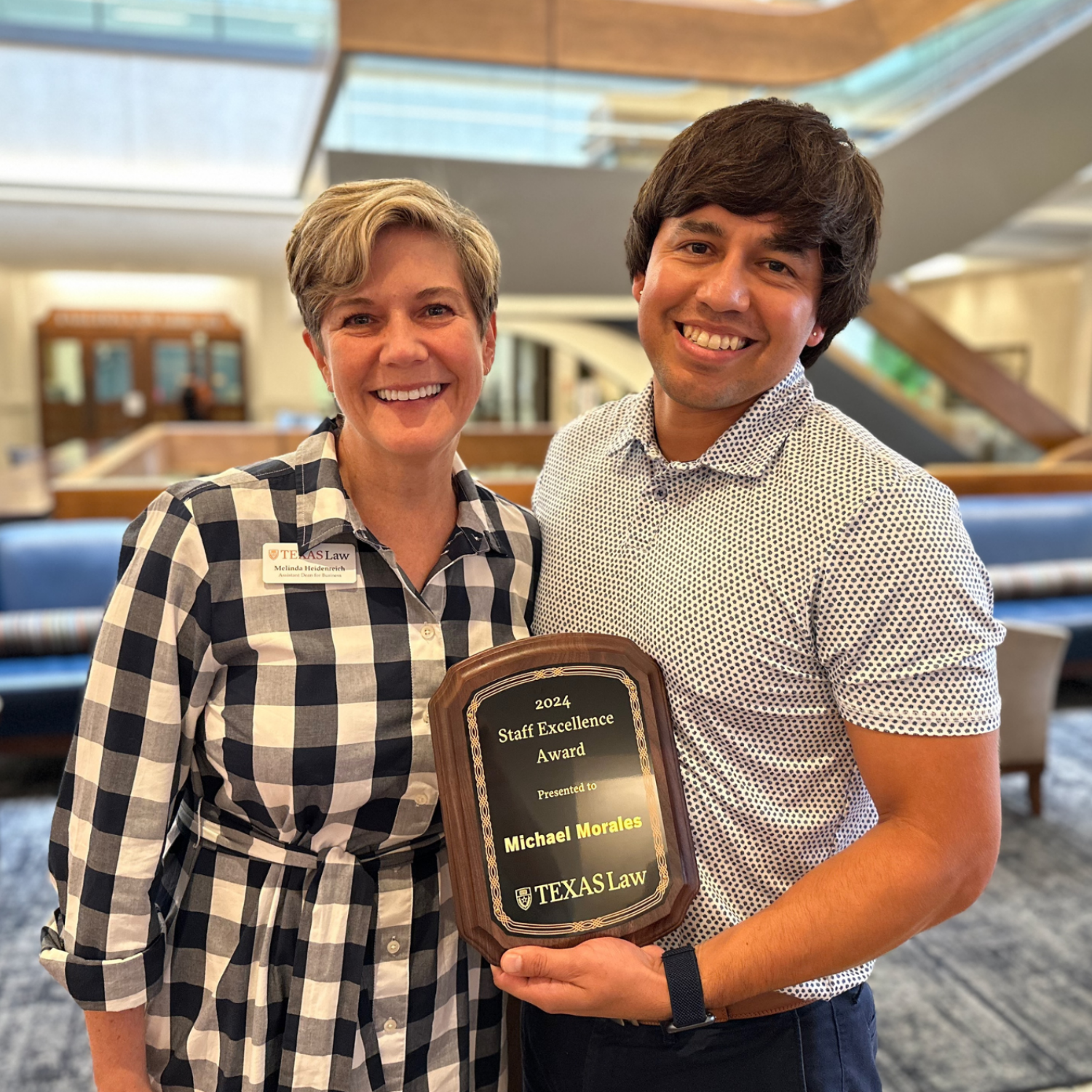 Michael Morales holds his 2024 Employee of the Year award and poses with Melinda Heidenreich