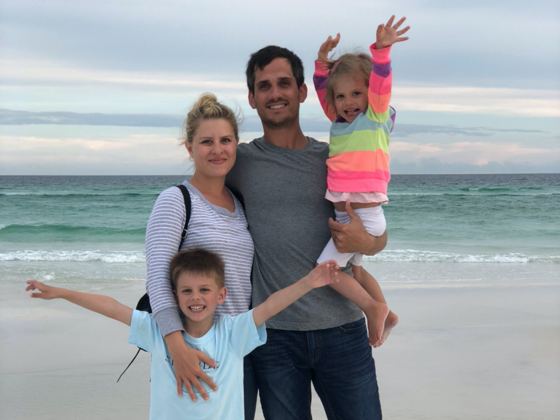 Emily Bamesberger pictured with her husband and two kids at the beach