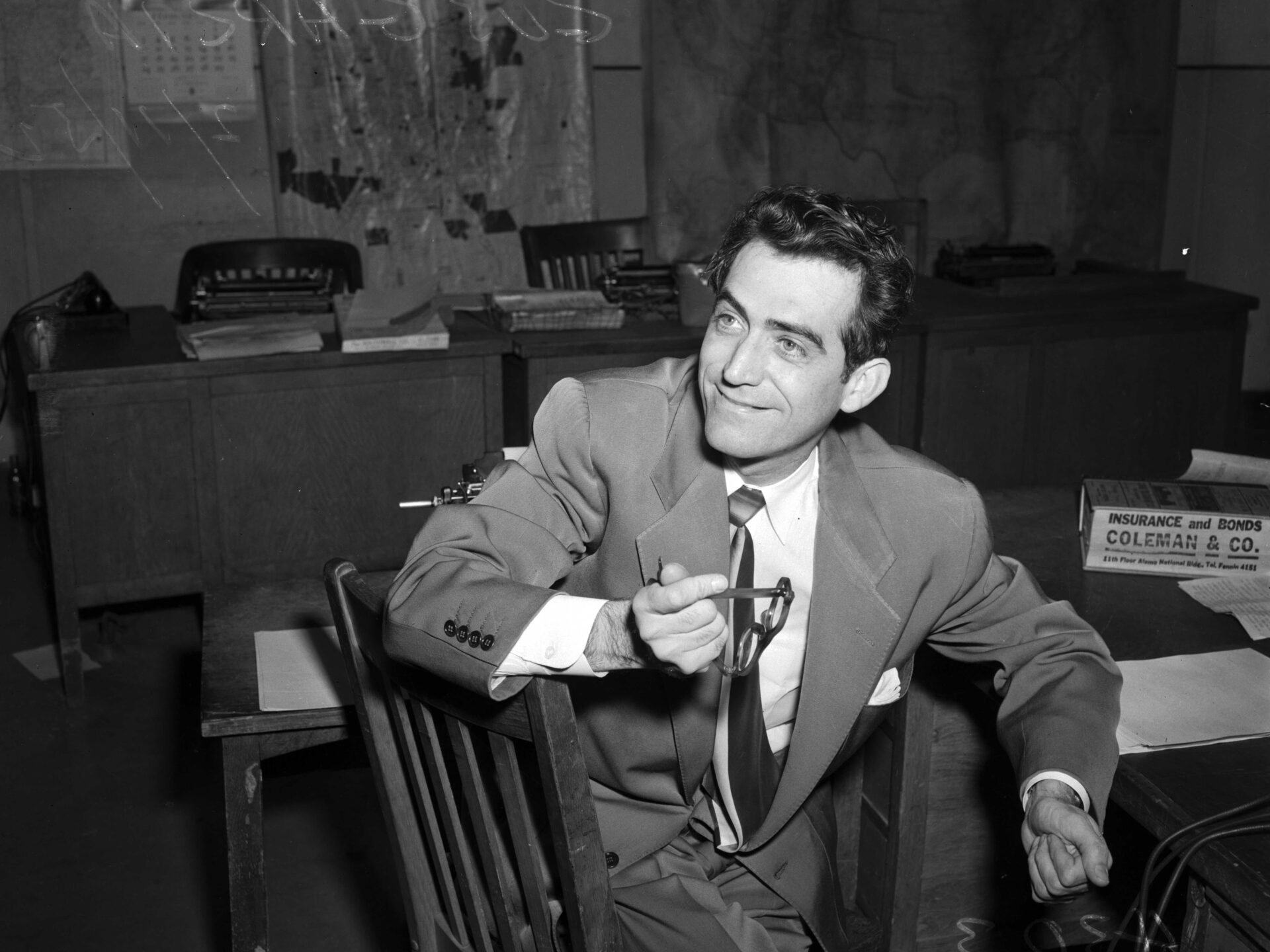 Black and white photograph from 1953 of attorney Gustavo Garcia sitting at a desk in his office.