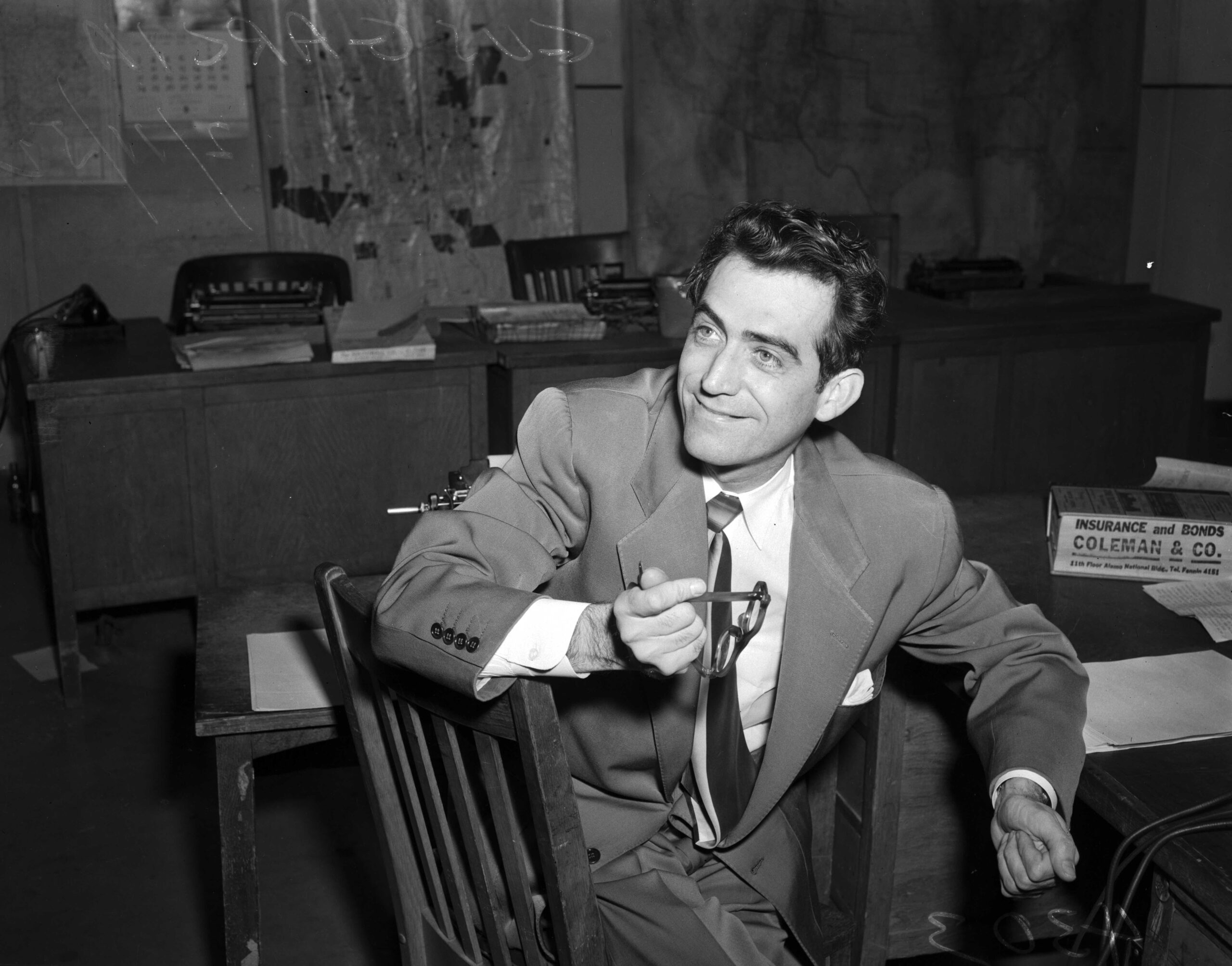 Black and white photograph from 1953 of attorney Gustavo Garcia sitting at a desk in his office.