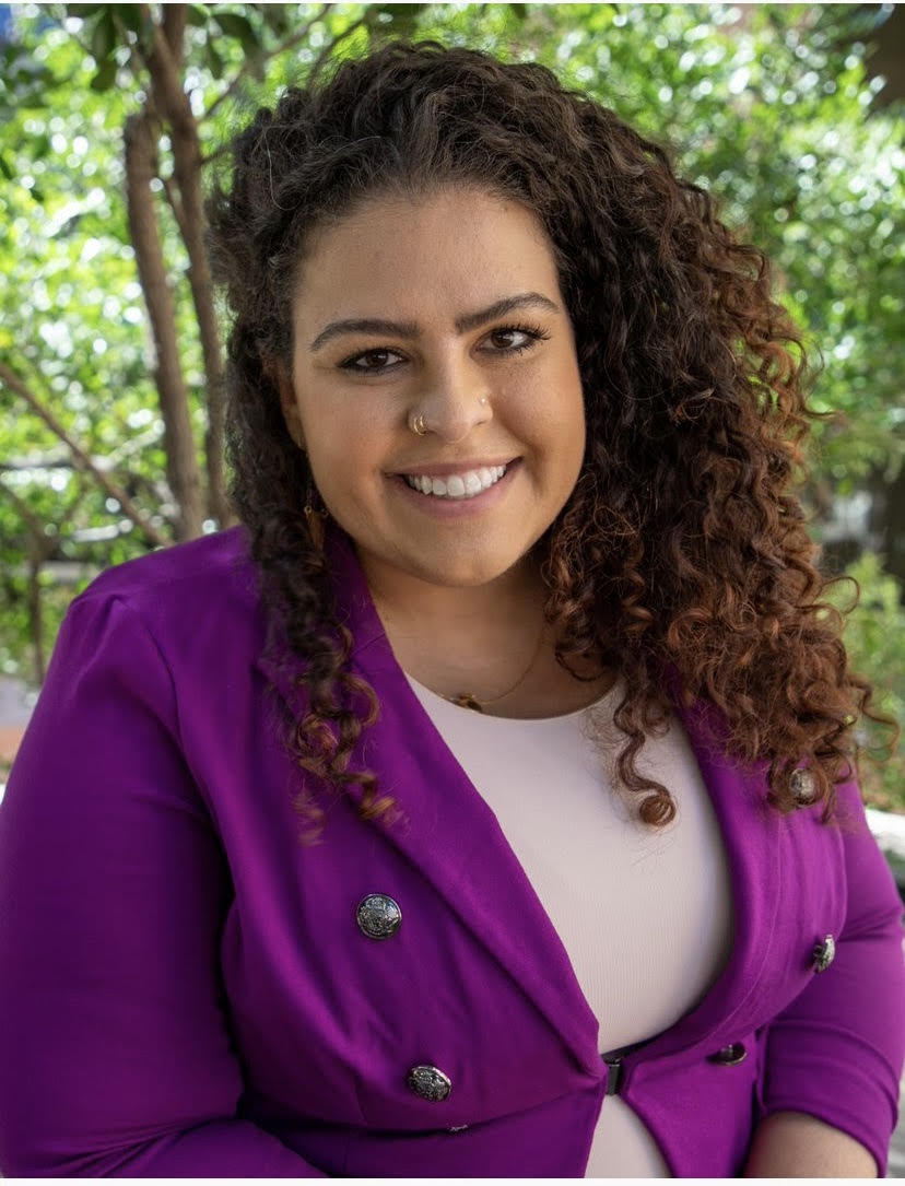 Rhiannon Hamam wearing a purple blazer