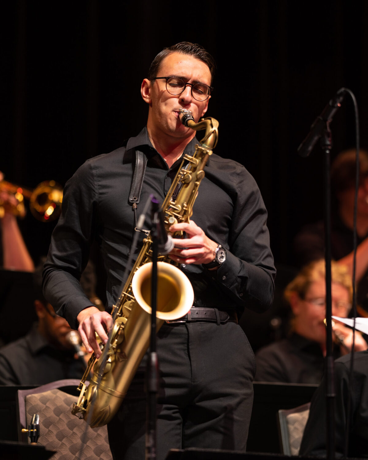 Photograph of Gavin Lopez playing a tenor saxophone in concert.