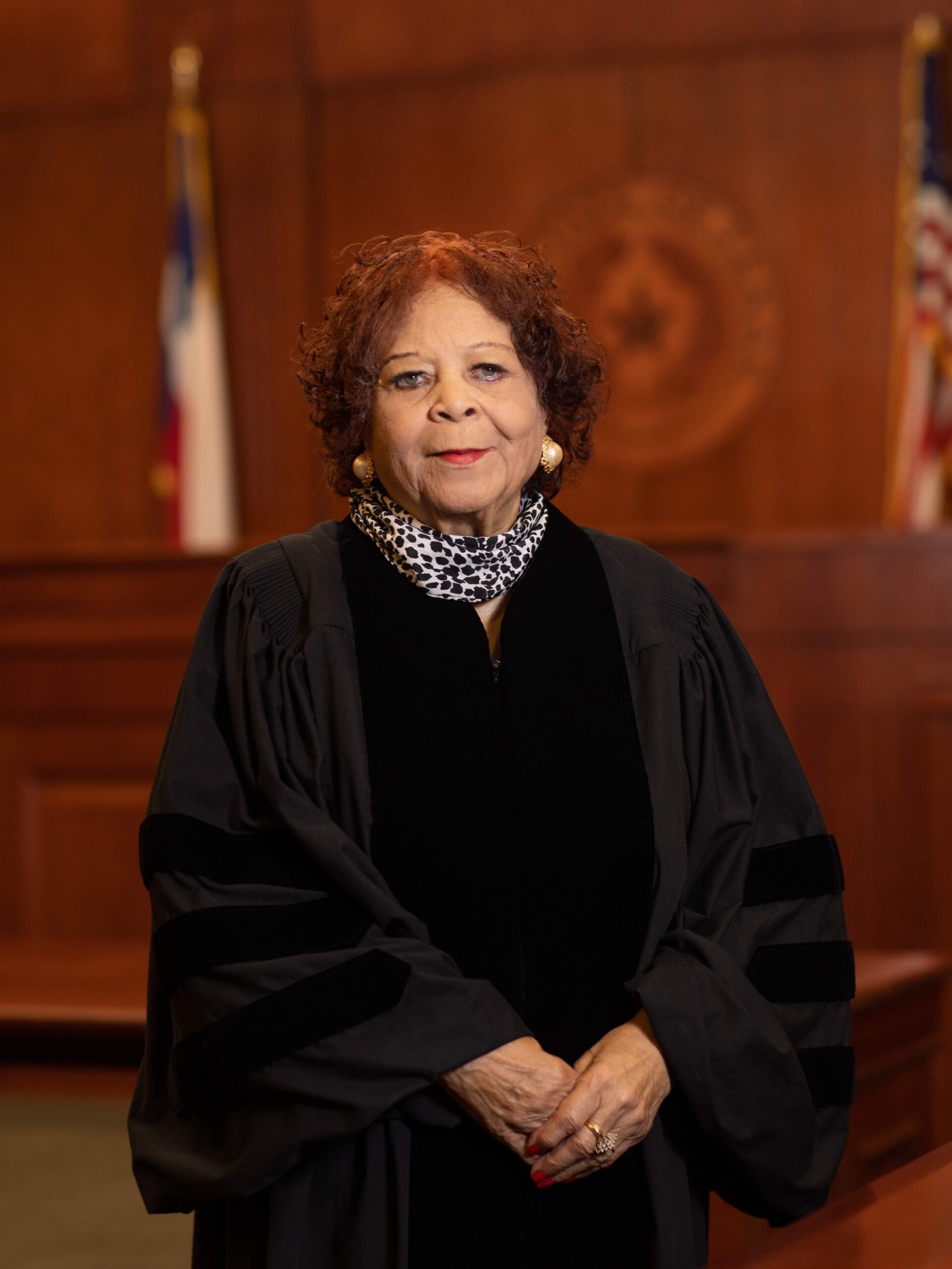 A portrait of Judge Harriet Murphy in her judicial robes, standing in the law school courtroom.