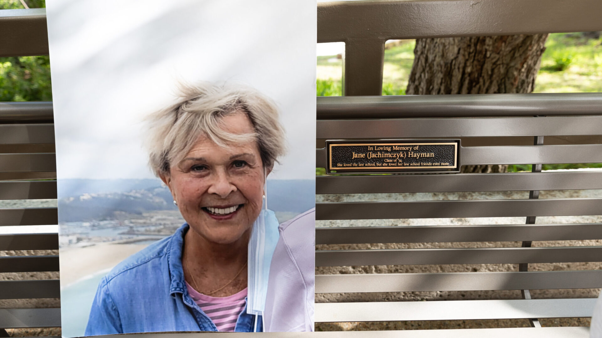 A photograph of Jane Hayman at the Friendship Bench during the dedication ceremony.