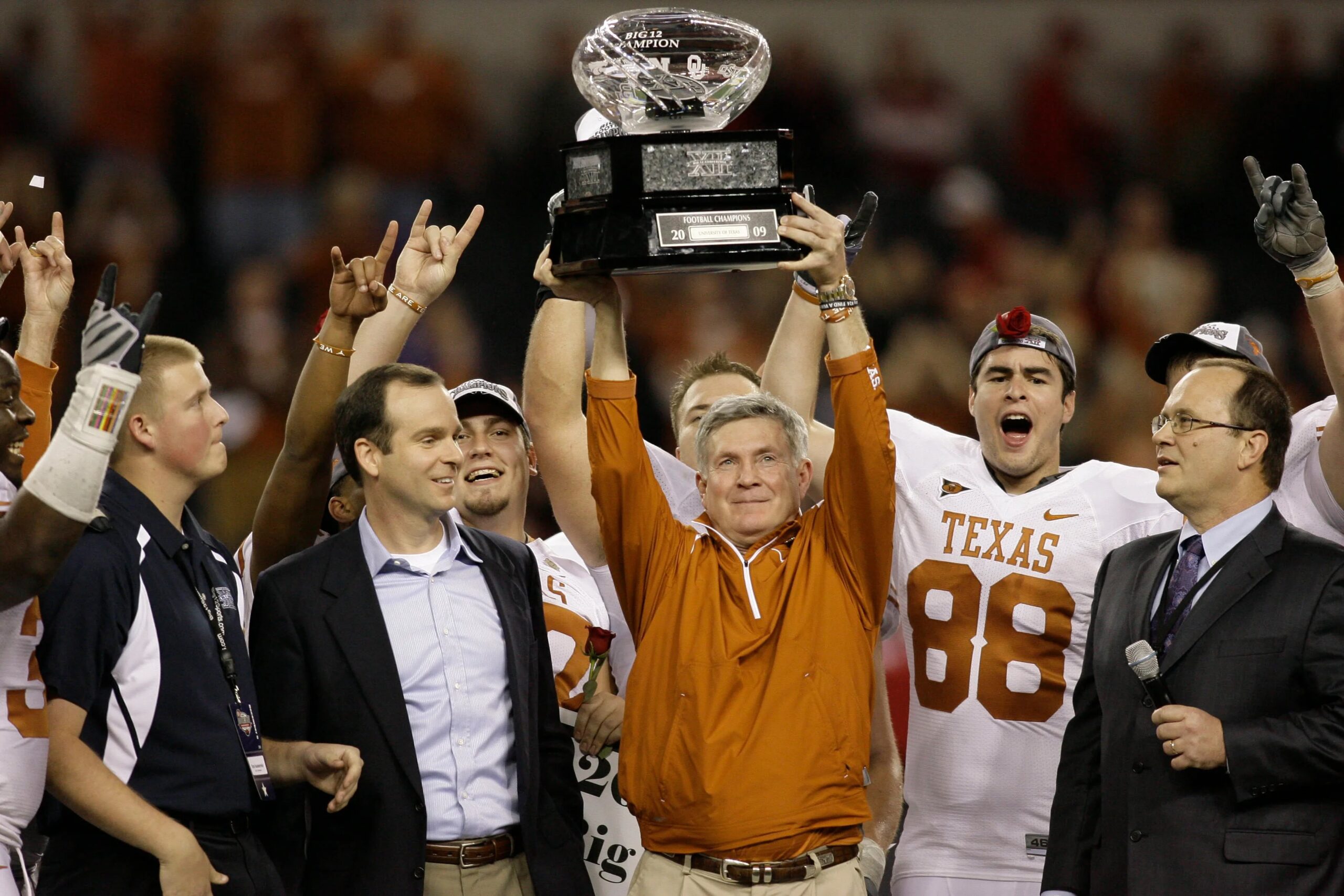 Texas Longhorns head coach Mack Brown accepts the Big 12 championship trophy after a victory against the Nebraska Cornhuskers in the 2009 Big 12 championship game at Cowboys Stadium. Texas defeated Nebraska 13-12. Mandatory Credit: Brett Davis-USA TODAY Sports