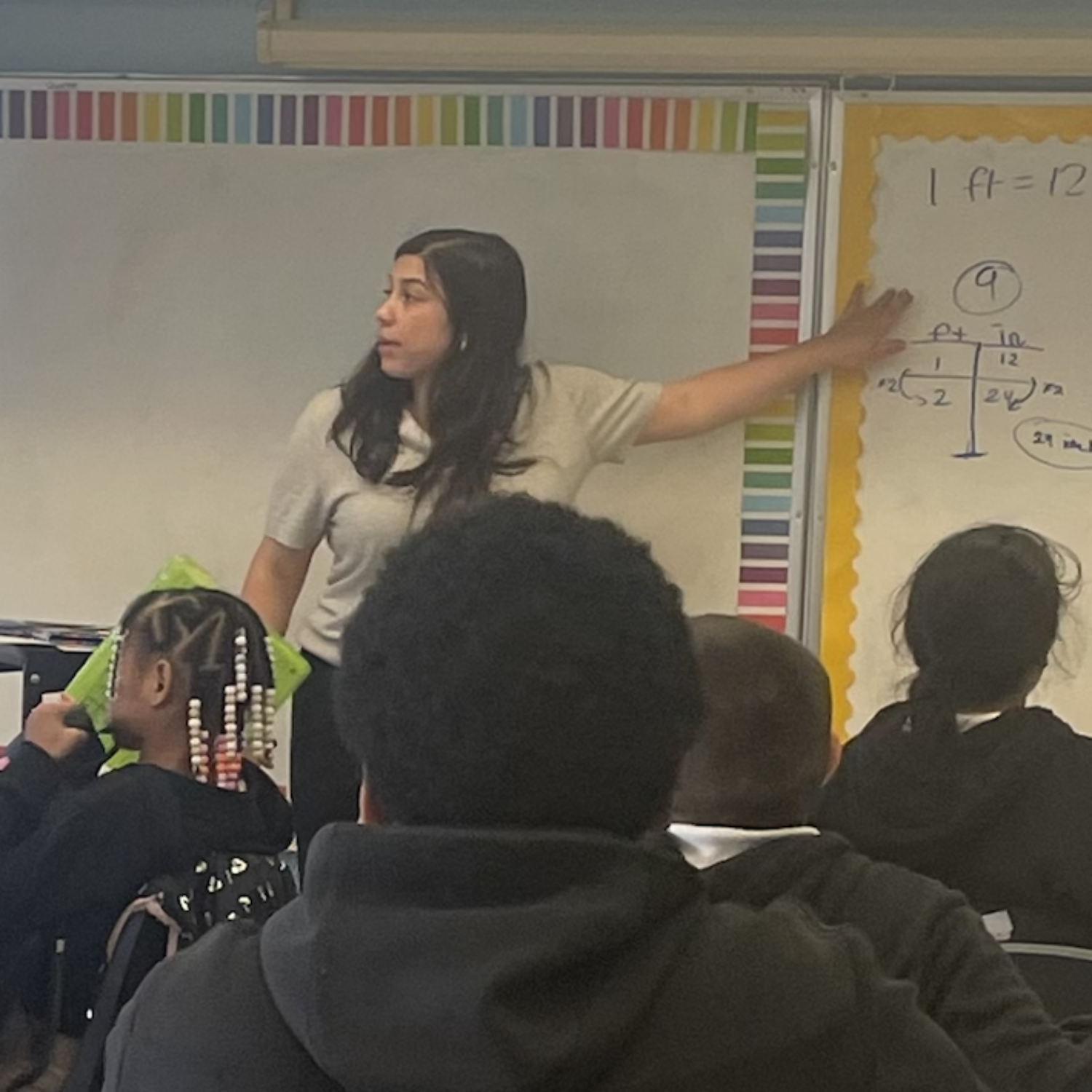 Maggie Coster teaching in front of class