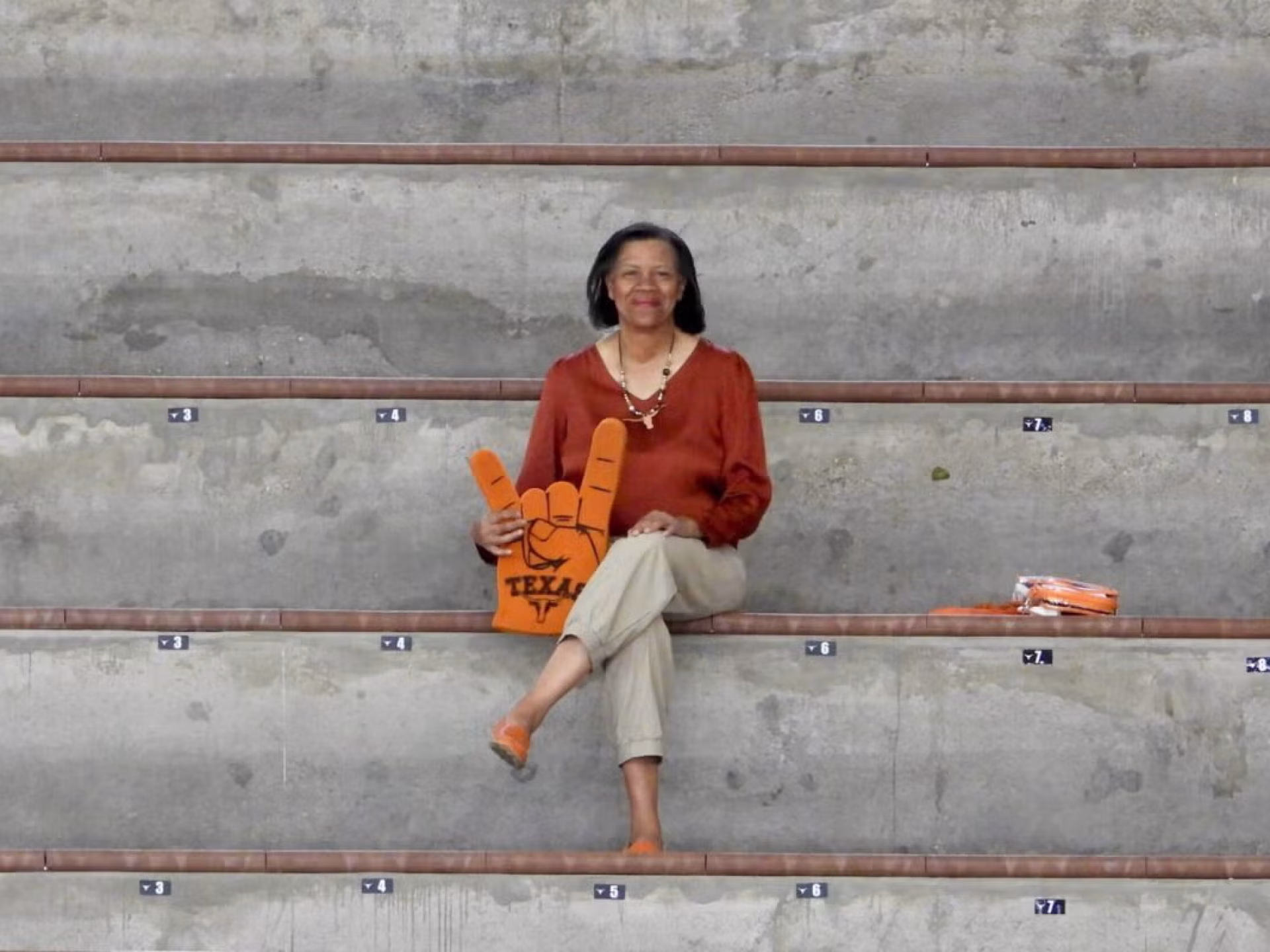 Professor Mechele Dickerson seated on bleachers