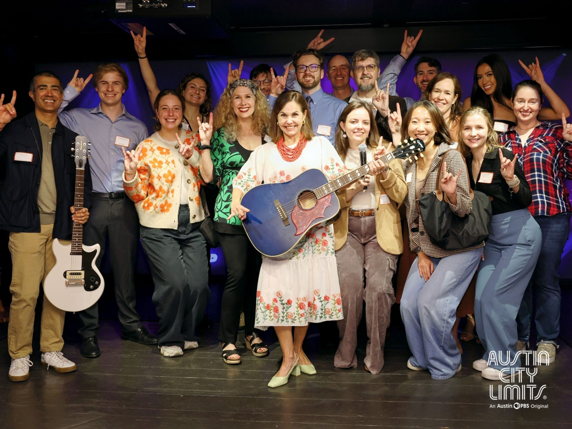 Photo of Rémi Ratliff (center) with group of alumni mentors and student mentees at Austin City Limits.