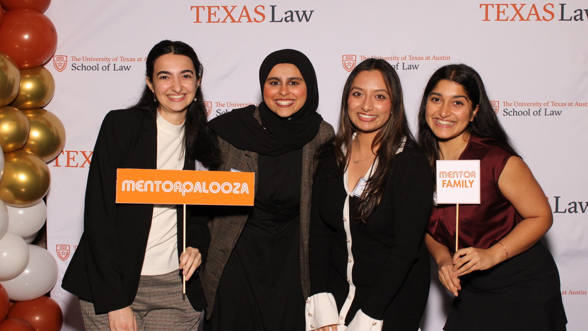 Four women holding Mentorpalooza signs