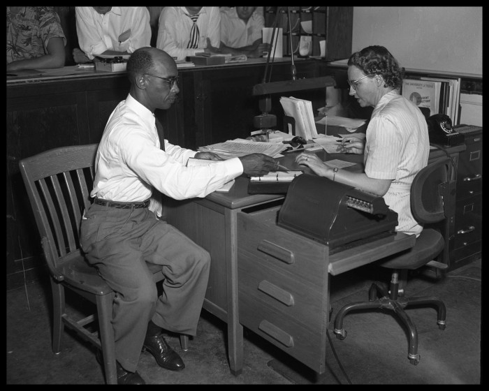 Heman Sweatt completing his registration paperwork.