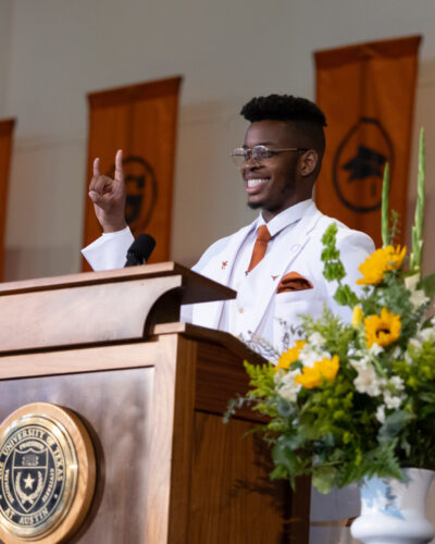 Class president Jason Onyediri stands at the podium during graduation.