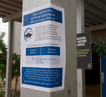 A flyer hangs on a post announcing free DACA clinics.