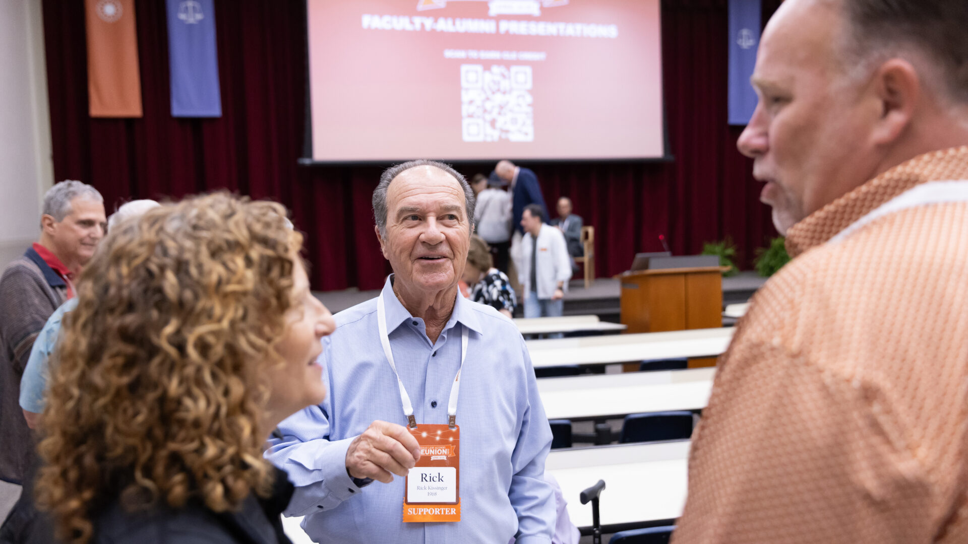 alumni visit after a panel discussion