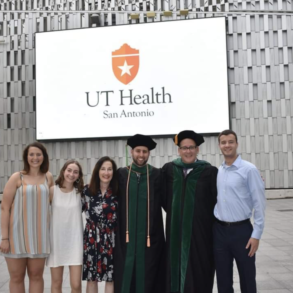 Terry Stolow pictured with her family in front of a UT Health sign