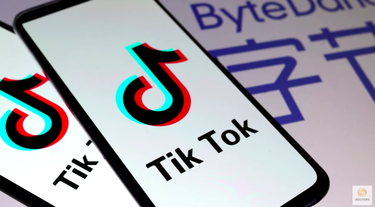 Graphic of a cell phone with the Tik Tok logo of a music note in black, red, and light blue.