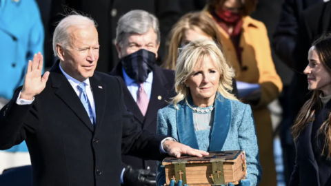 Joe Biden, with his left hand on a Bible and his right hand in the air, is sworn in as 46th president of the United States on Wednesday in Washington. Jill Biden is standing next to him, holding the Bible.