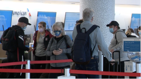 Lines of people wearing masks at airport