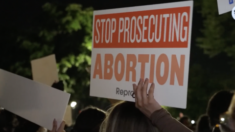Abortion protestors with sign "Stop Prosecuting Abortion"
