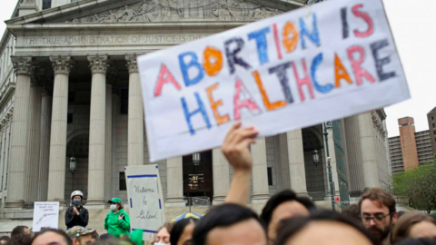 Abortion protestors outside SCOTUS with sign "Abortion is Healthcare"