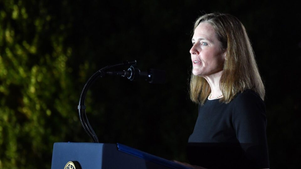 Justice Amy Coney Barrett at the White House, standing in front of a podium.