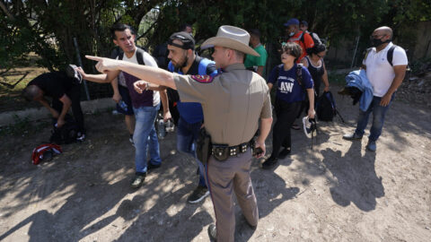 DPS officer talking to migrants
