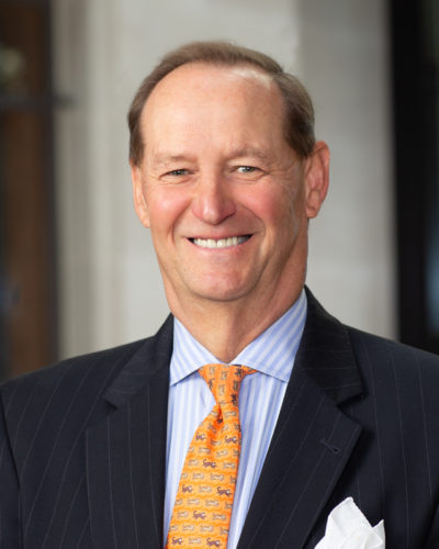 Portrait of Professor Erben, wearing a bright orange tie